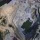 Aerial view of mining quarry with lots of machinery, excavators, trucks and drills - VideoHive Item for Sale