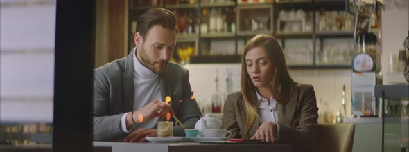 Caucasian man and woman sitting in cafe