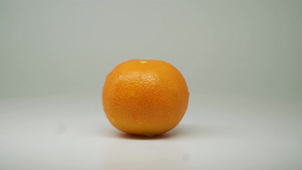 Fresh Orange Fruit On The Rotating Table With White Plain Background - Close Up Shot