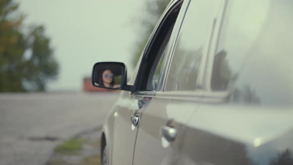 Driver Throwing Away Hamburger Box From Car Window on Road.