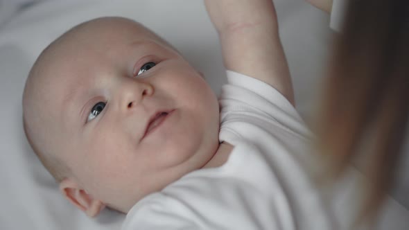 Close Up of Cheerful Little Child Playing with Caring Mother