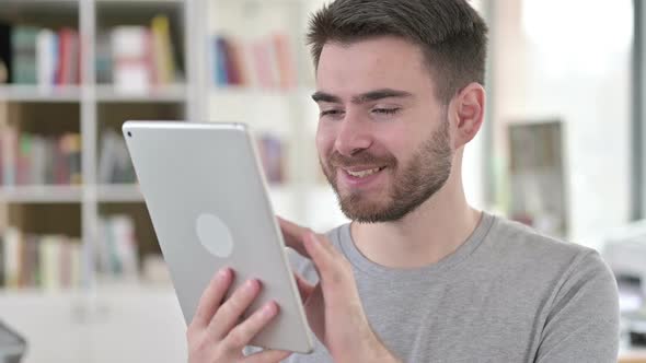 Portrait of Attractive Young Man Using Digital Tablet