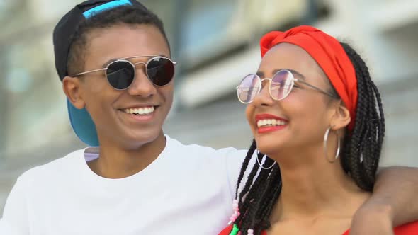 Happy Afro-American Teen Couple Laughing, Enjoying Show at Stadium, Leisure Time