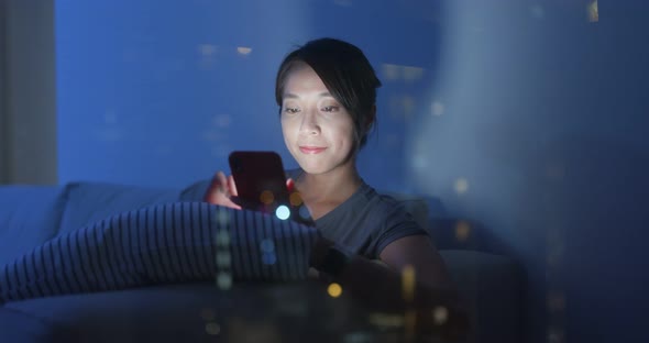 Asian Woman Look at The Mobile Phone for Online Shopping at Home in The Evening