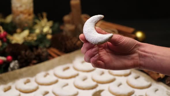 Woman Holding Traditional German or Austrian Vanillekipferl Vanilla Kipferl Cookie