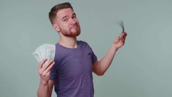 Proud Arrogant Rich Happy Man Holding Money Cash in Dollars Banknotes Smiling Looking at Camera