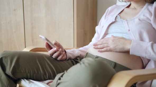 Pregnancy, People And Technology Concept. Pregnant Woman Using Smartphone.