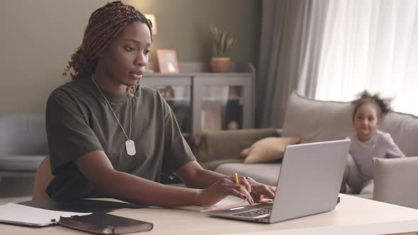 Female Soldier Working on Laptop from Home alt