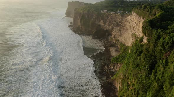 Aerial View of Rocky Coast with Big Waves at Sunset