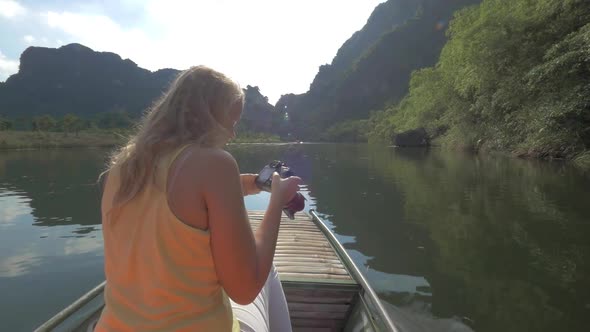 Woman tourist taking shots of Trang An nature, Vietnam