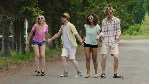 Four Young Excited People Jumping, Enjoying Holidays Outdoors, Summer Weekend