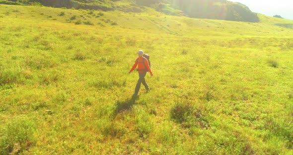 Flight Over Backpack Hiking Tourist Walking Across Green Mountain Field