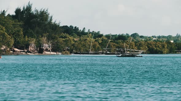 View From Ocean to Wooden Fishing Boats Anchored Near Coast of African Village