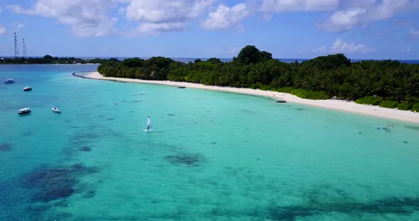 Wide above copy space shot of a white paradise beach and aqua turquoise water background in vibrant 