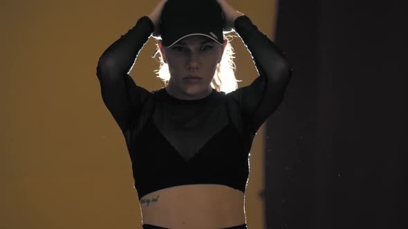 Blonde Woman Dancing on the Background of Bright Lighting