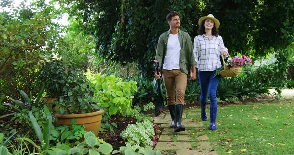 Romantic couple walking hand in hand in park