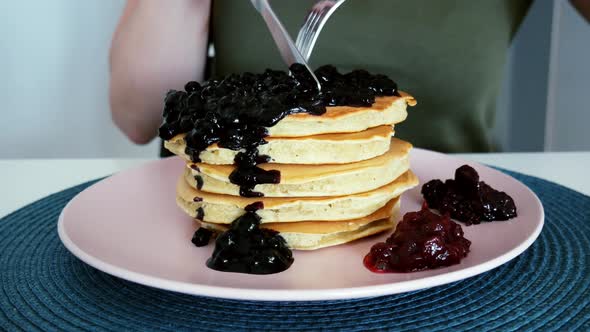 Woman Eating Berries Pancakes with Knife and Fork, Foreground, Morning Breakfast