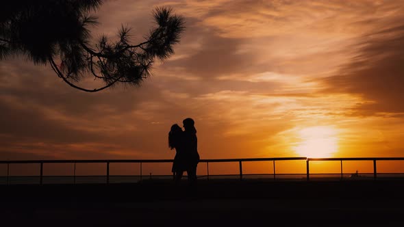 Couple Silhouette at the Beach Sunrise