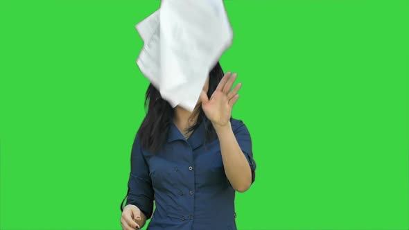 Confident Asian Businesswoman Tearing the Paper Into Small Pieces and Throwing It on a Green Screen