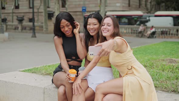 Three Young Lovely Women of Different Races Making Selfie at Meeting Outdoors on Summer Day