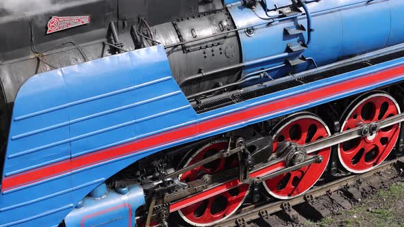 A World War II Steam Locomotive Moves Slowly and Blows Steam