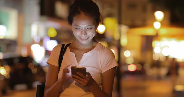 Woman Using Mobile Phone at Night