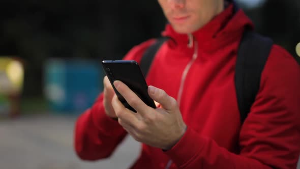 Unrecognizable Person with Smartphone in the Park