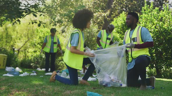 Happy family cleaning a garden together