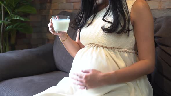Pregnant Woman Drinking Milk at Home