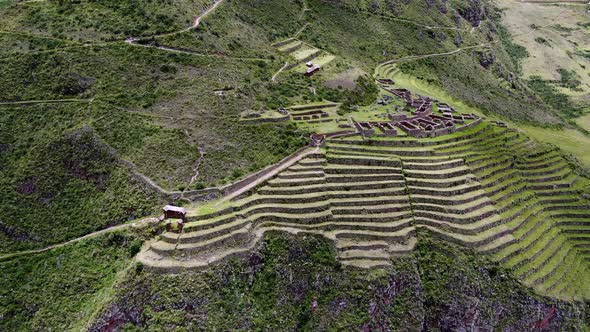 Stone Structures On Hilltop With Terraces In Inca Ruins, Sacred Valley, Cusco Peru. Aerial Shot