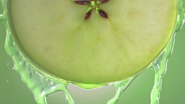 Flowing Green Apple Juice From Apple Slice  Macro Shot in Slow Motion