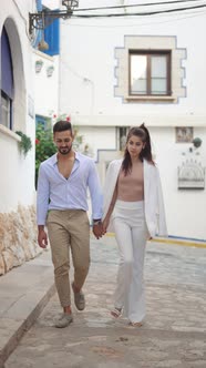 Stylish Ethnic Couple Walking in Small Town