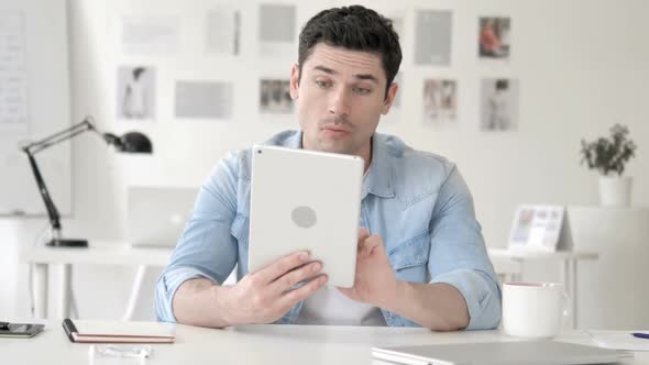 Casual Young Man in Shock While Using Tablet