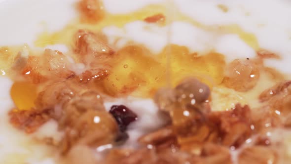 Macro Shot - Drop of Mountain Honey for Granola and Yogurt. The Concept of a Healthy Diet, Fitness