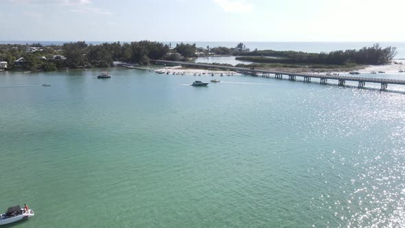 aerial of groups of boaters line the shores at Longboat Pass in Sarasota, Florida