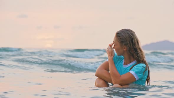 Woman Sitting on Water Sea