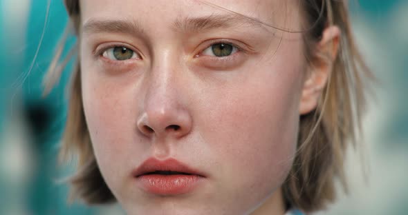 Close up Of cinfident Girl, Baby Face Model looking thoughtfully to the Camera