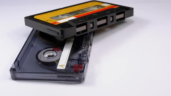 Two Vintage Audio Cassette Rotates on White Background