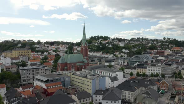Old And Historic Trinity Church Surrounded By The Typical Houses And Buildings In Arendal, Agder Cou alt