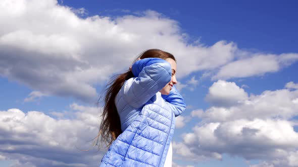 Happy Child in Autumn Jacket with Windy Hair Enjoy the Sun on Sky Background Haircut