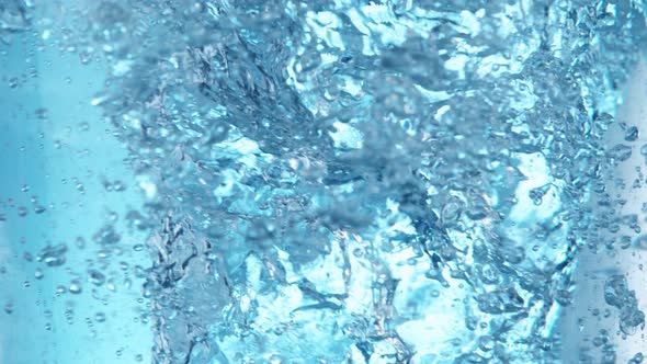 Super Slow Motion Shot of Water Whirl on Light Blue Background at 1000Fps alt