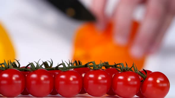 Cherry Tomatoes on a Background of Yellow Sweet Pepper