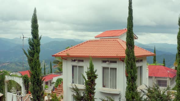 Rancho la vereda house and landscape in background, San Jose de Ocoa. Aerial pedestal up