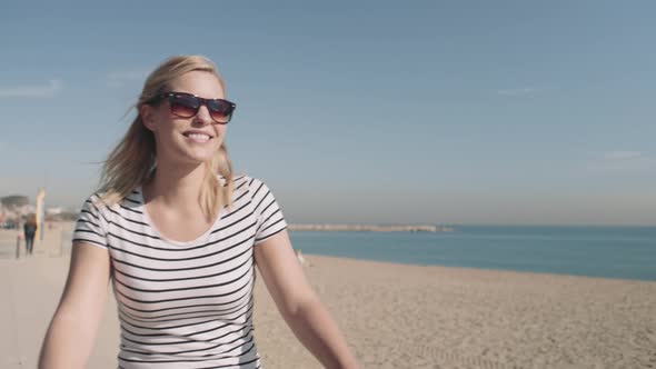 Young Adult Female Tourist cycling on beach in summer