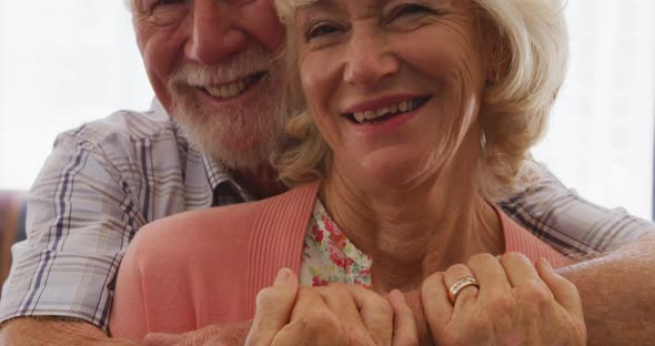 Senior couple in social distancing smiling at camera