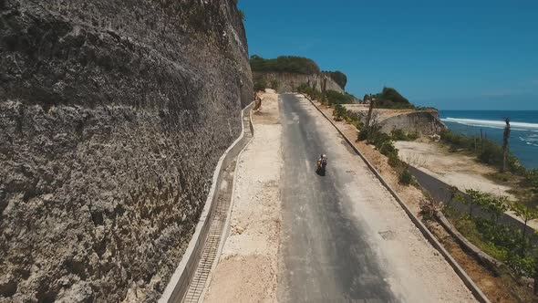 Family on a Motorcycle Rides Along the Road