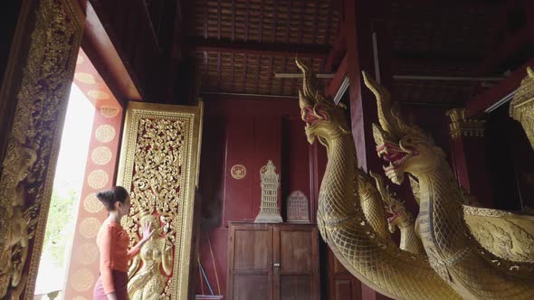 Beautiful Asian Girl Walking At Wat Xieng Thong Landmark In Luang Prabang