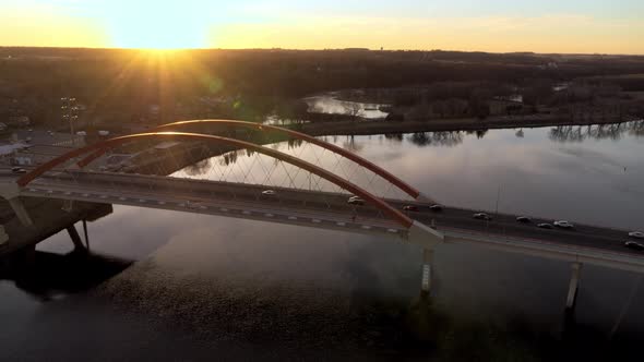 Orbiting aerial view of Hastings Bridge as the sun goes down on the horizon