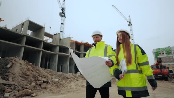 Man and Woman are Walking in Building Site Foreman and Female Building Inspector are Checking