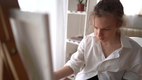 Portrait of Caucasian Young Artist Girl Coloring on Painting Board at Home